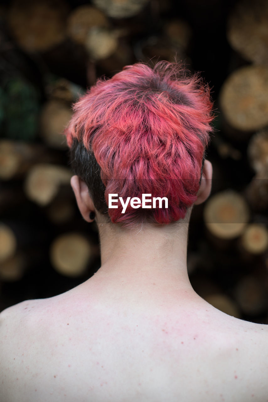 Rear view of shirtless man with dyed hair