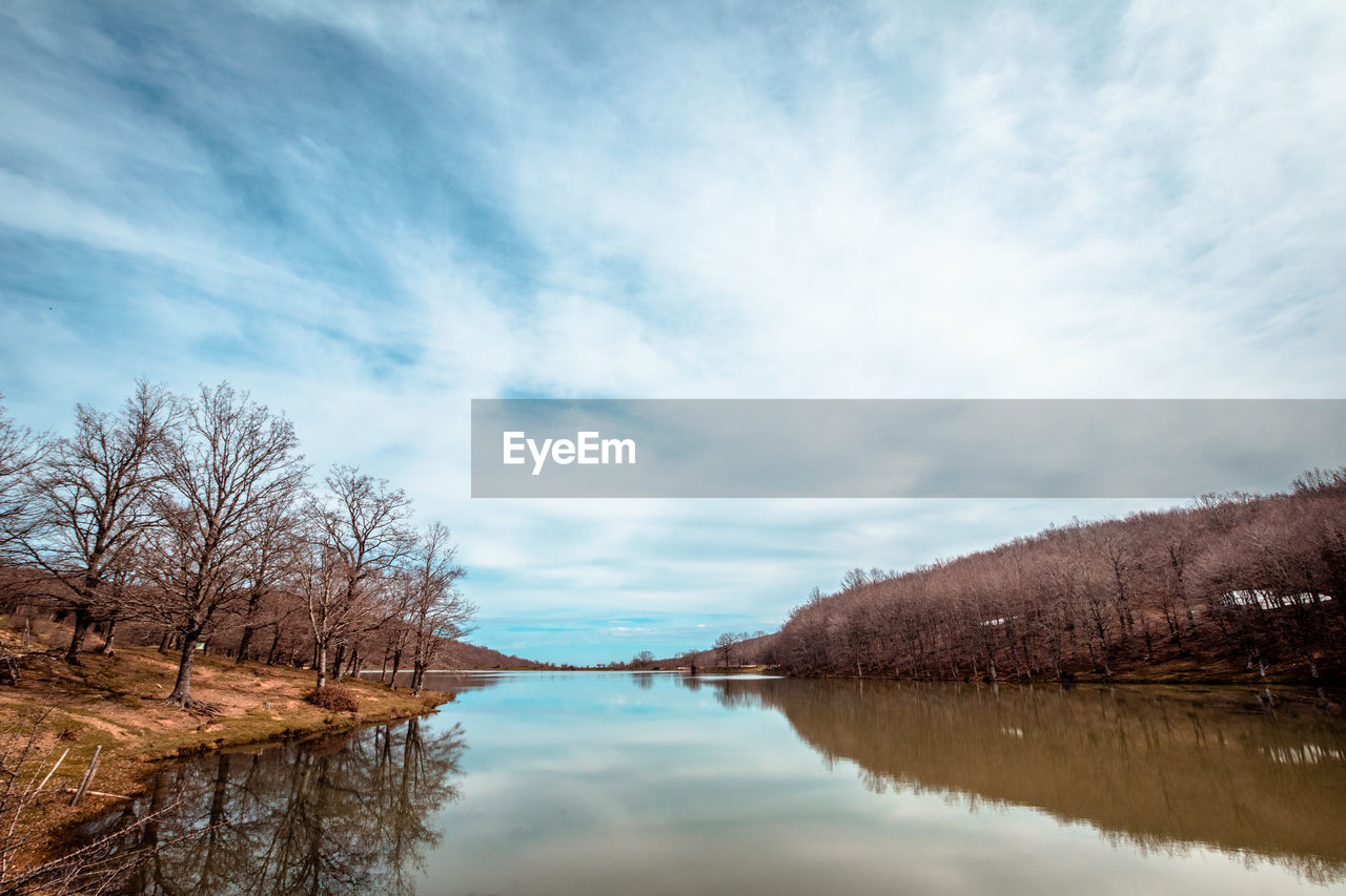 SCENIC VIEW OF LAKE AND TREES AGAINST SKY