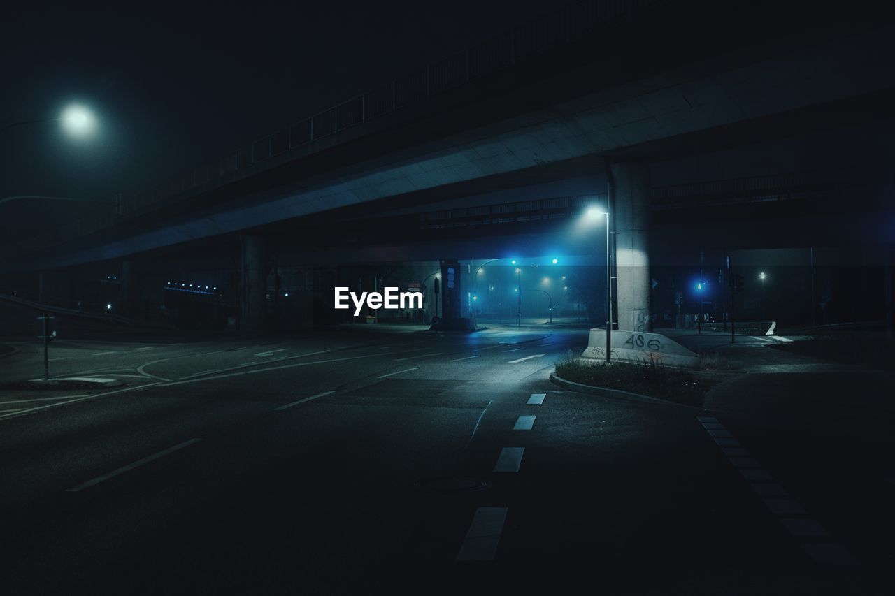 VIEW OF ILLUMINATED STREET AT NIGHT