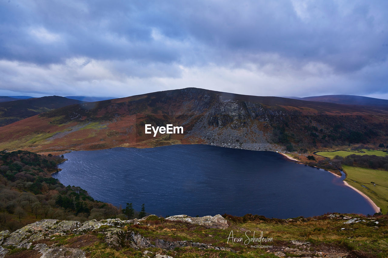 Scenic view of lake and mountains against sky