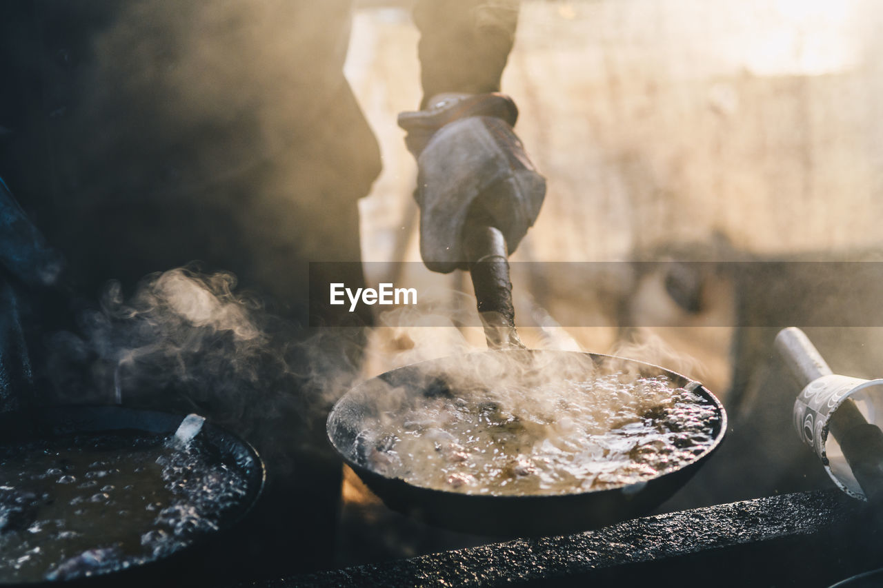 Cropped image of hand preparing food