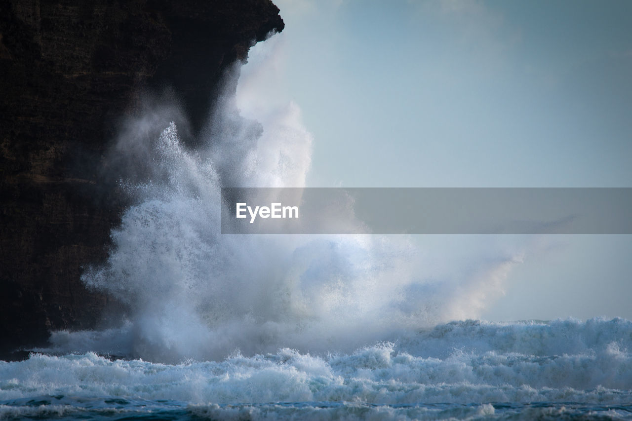 SEA WAVES SPLASHING ON ROCKS