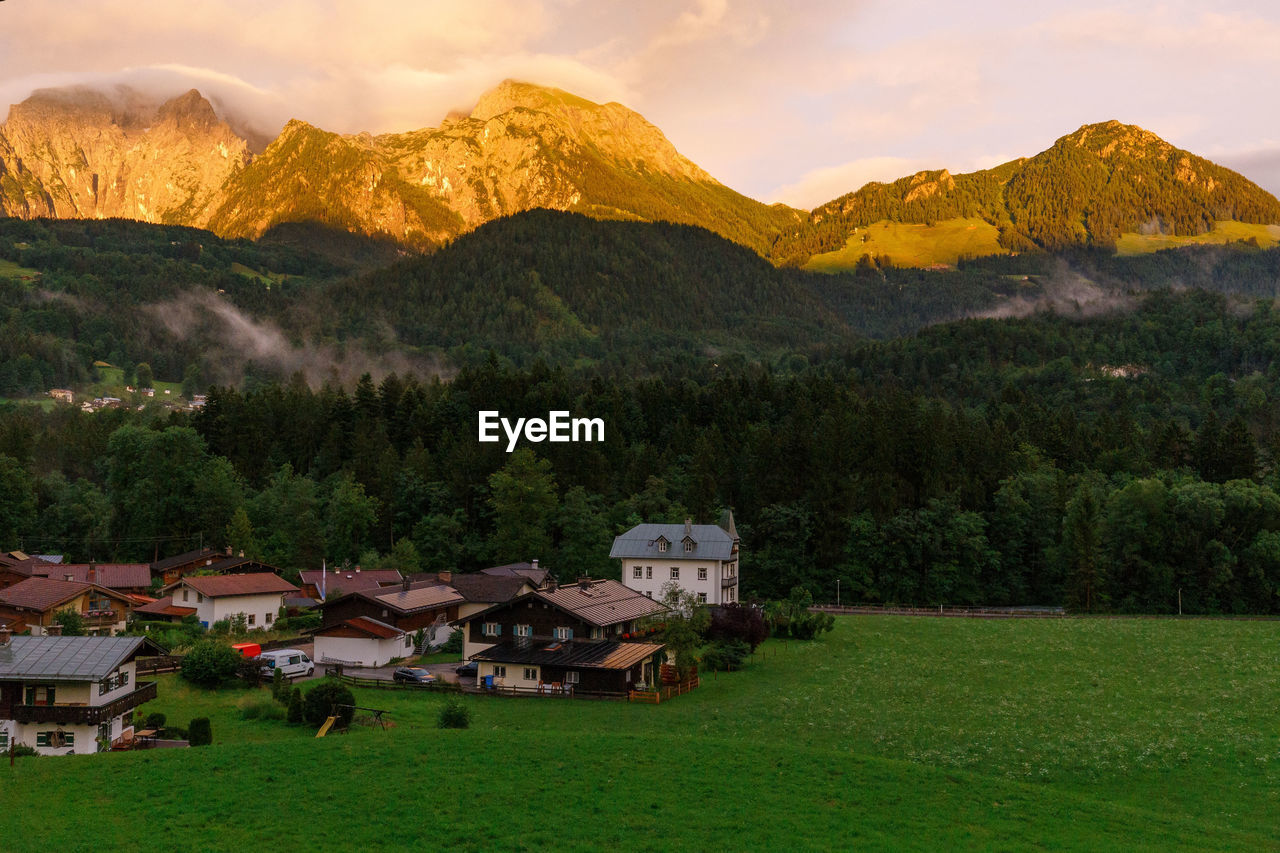 Houses on mountain against sky