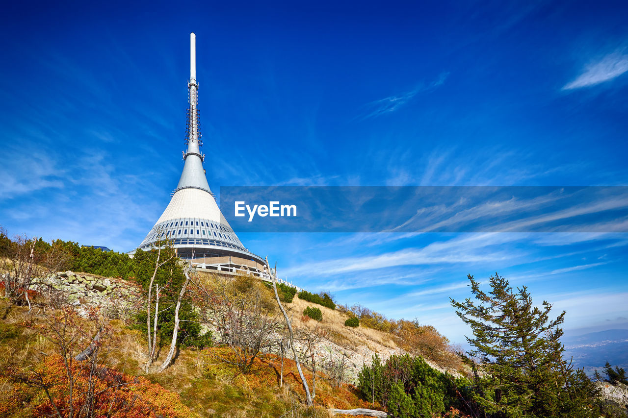 LOW ANGLE VIEW OF TOWER AGAINST CLOUDY BLUE SKY