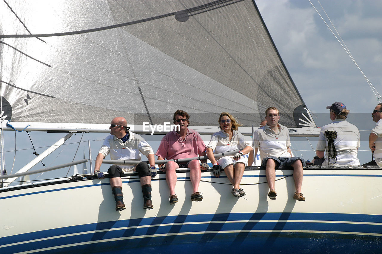 PEOPLE ON BOAT AGAINST SKY