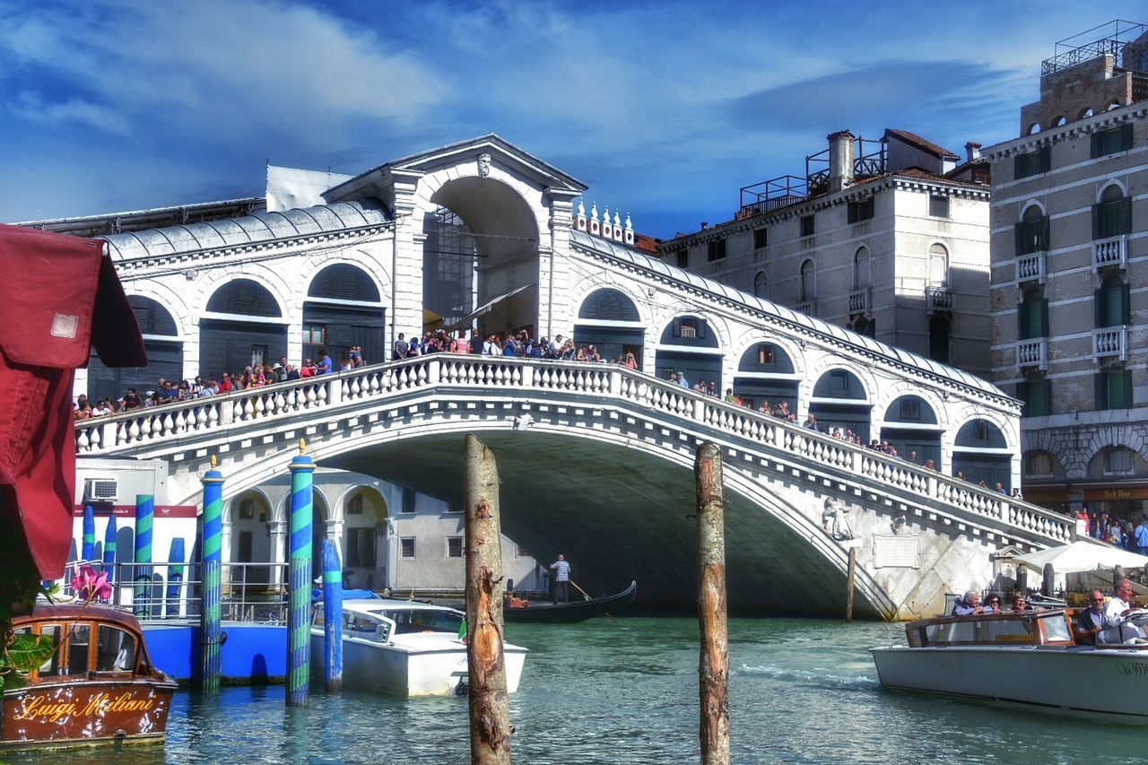People at rialto bridge over grand canal