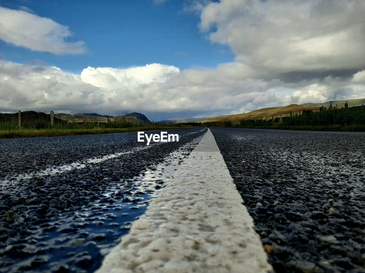 SURFACE LEVEL OF EMPTY ROAD AGAINST SKY