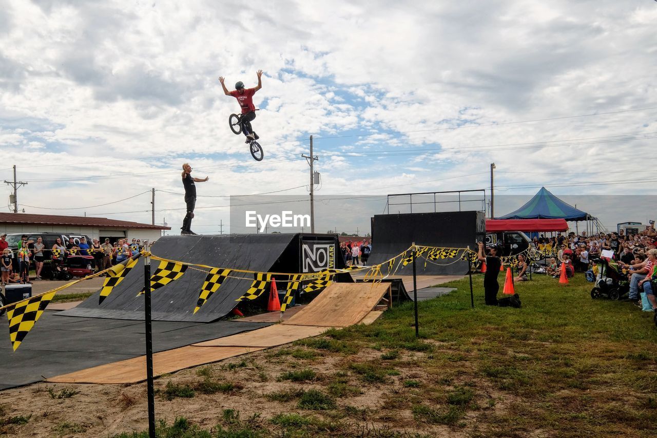 PEOPLE JUMPING AT FARM