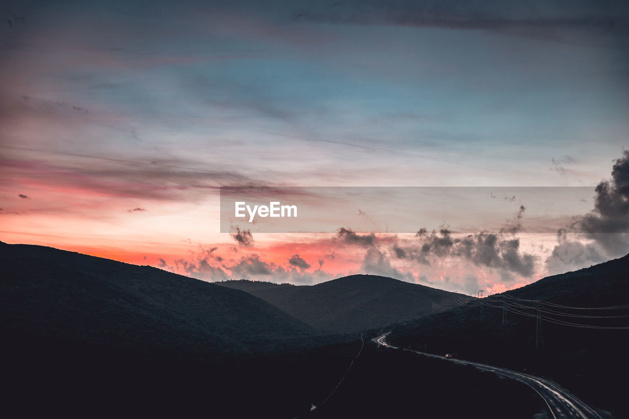 Scenic view of silhouette mountains against sky during sunset