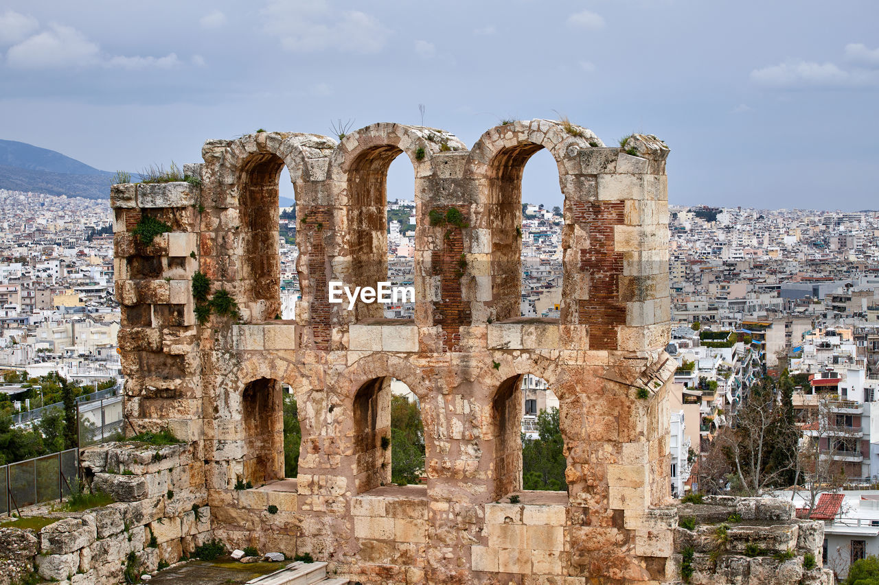 The odeon of herodes atticus with the city of athens in the background