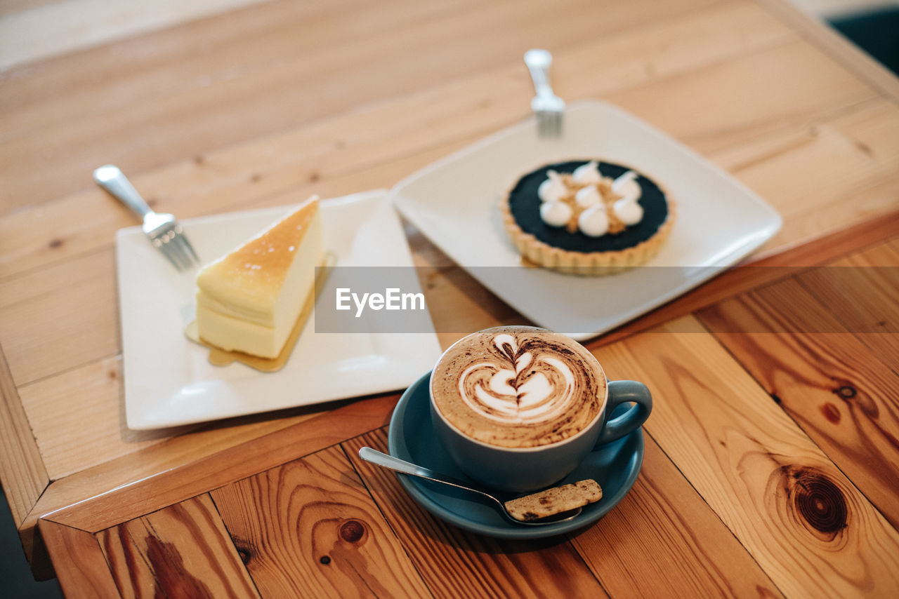 High angle view of coffee and cakes on table