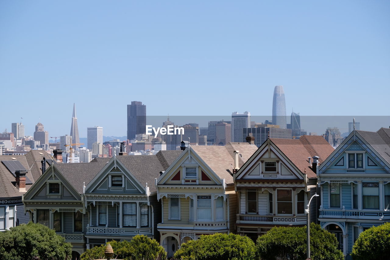 Buildings in city against clear sky