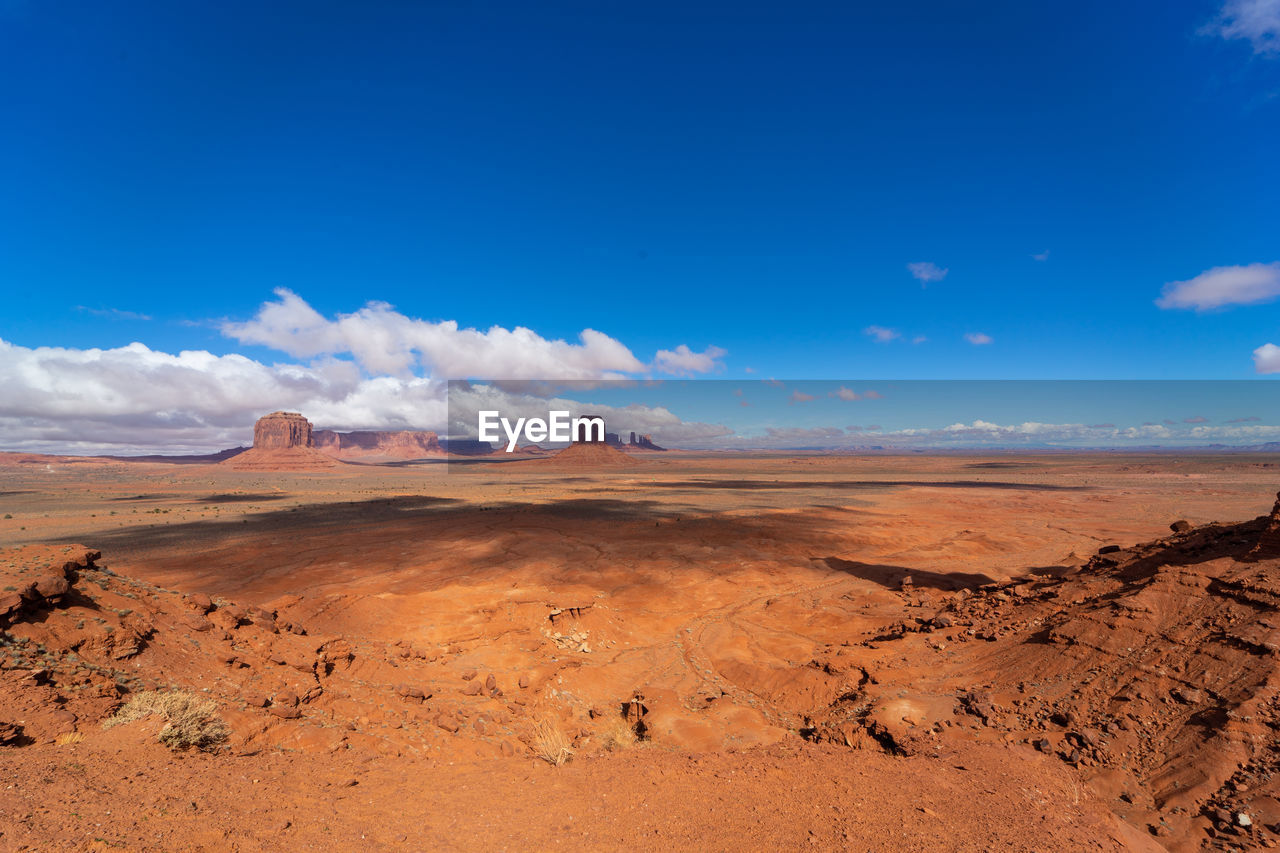 Scenic view of desert against blue sky