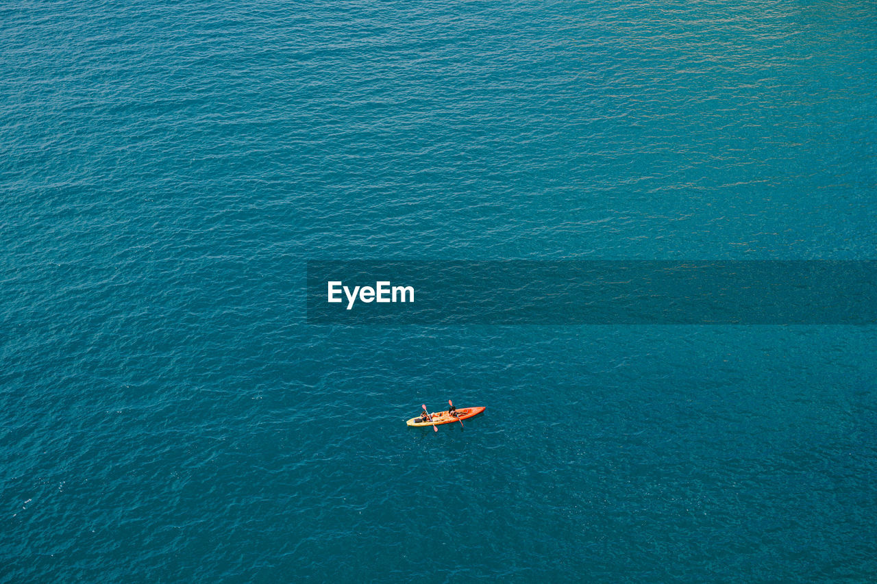 HIGH ANGLE VIEW OF PERSON IN SEA