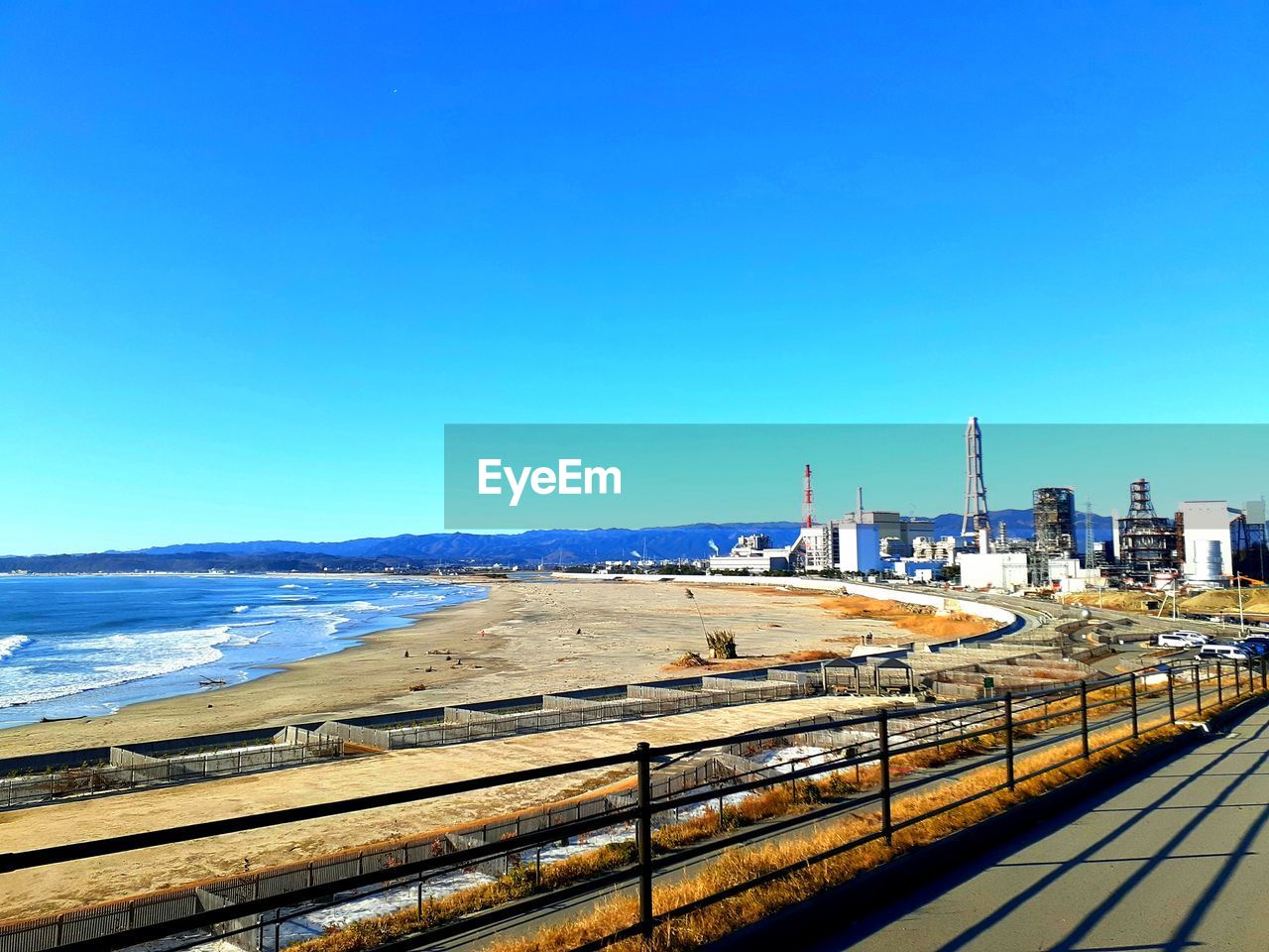 VIEW OF FACTORY AGAINST BLUE SKY