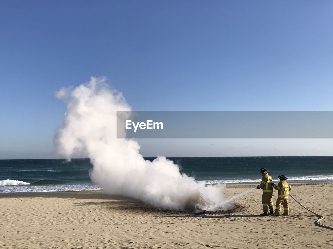 PEOPLE ON BEACH AGAINST SKY