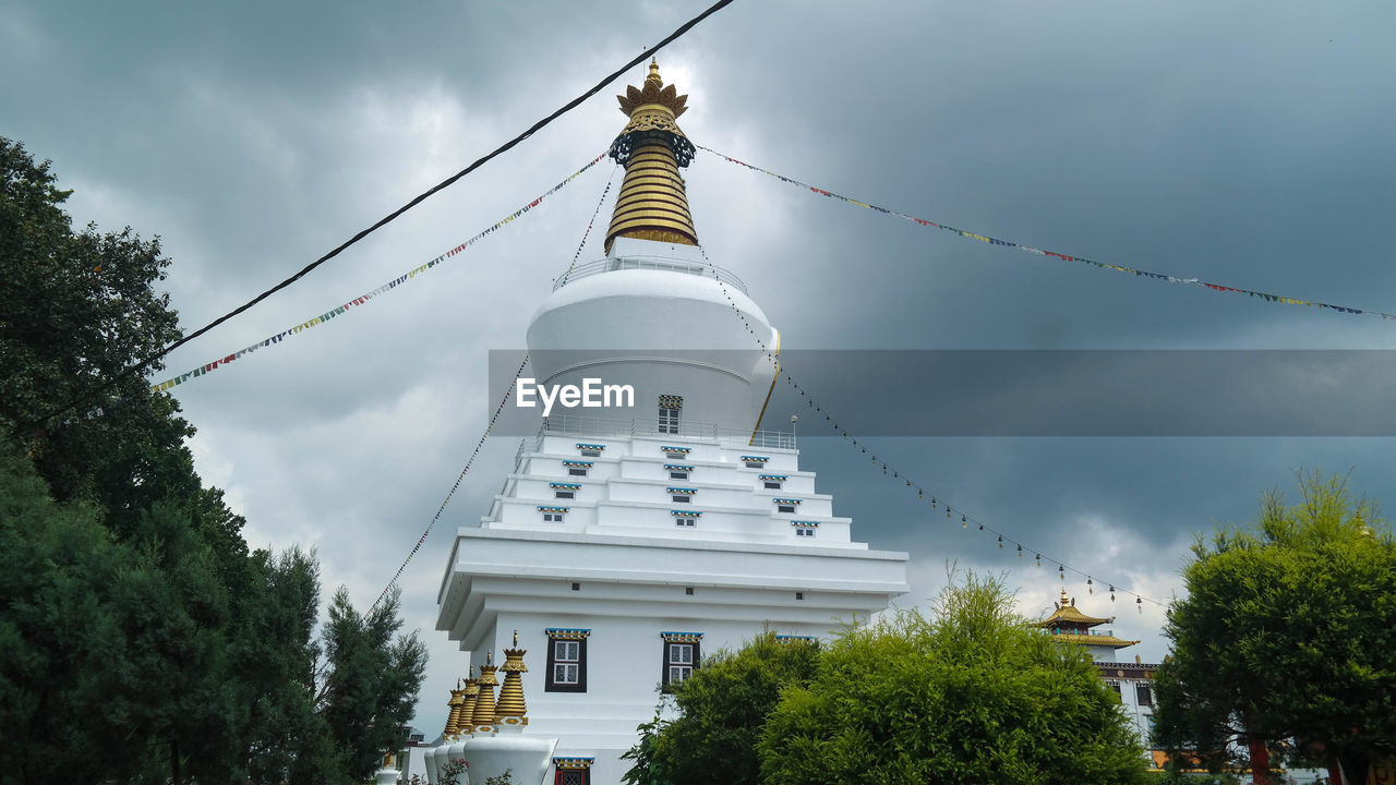 Low angle view of stupa against sky