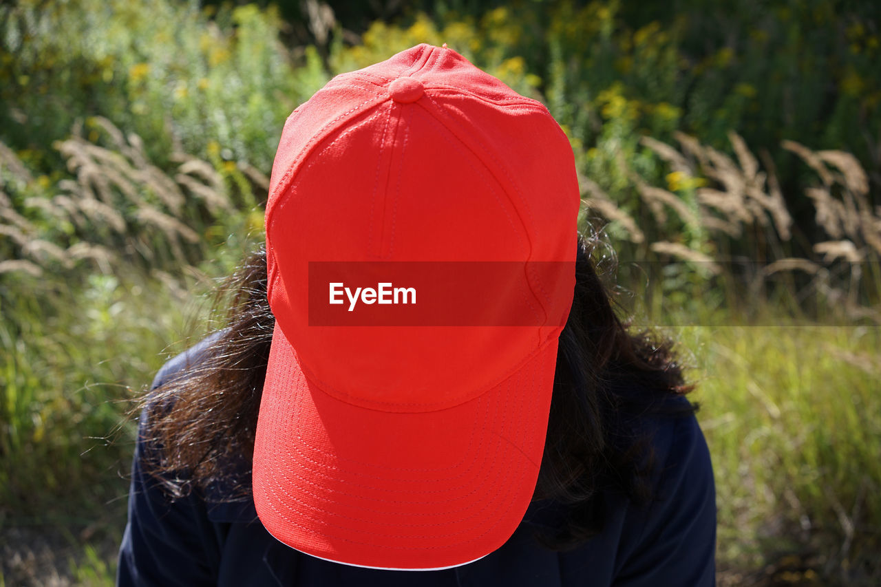 Rear view of woman wearing hat on field