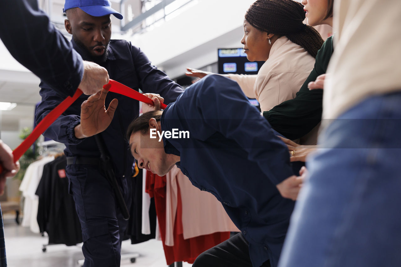 rear view of business colleagues stacking hands in office