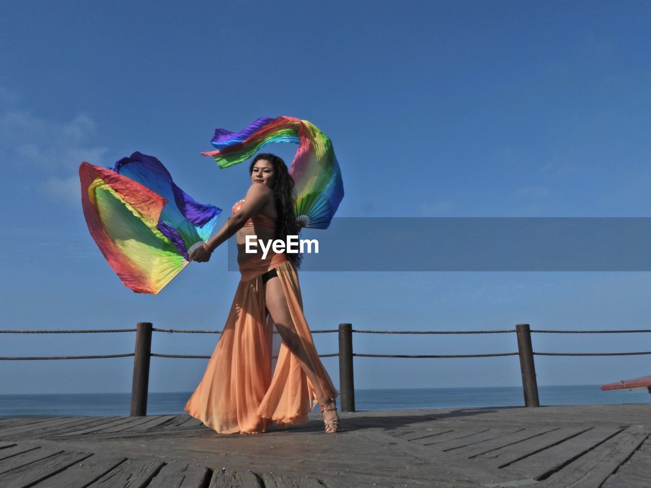 Woman dancing at observation point against sky