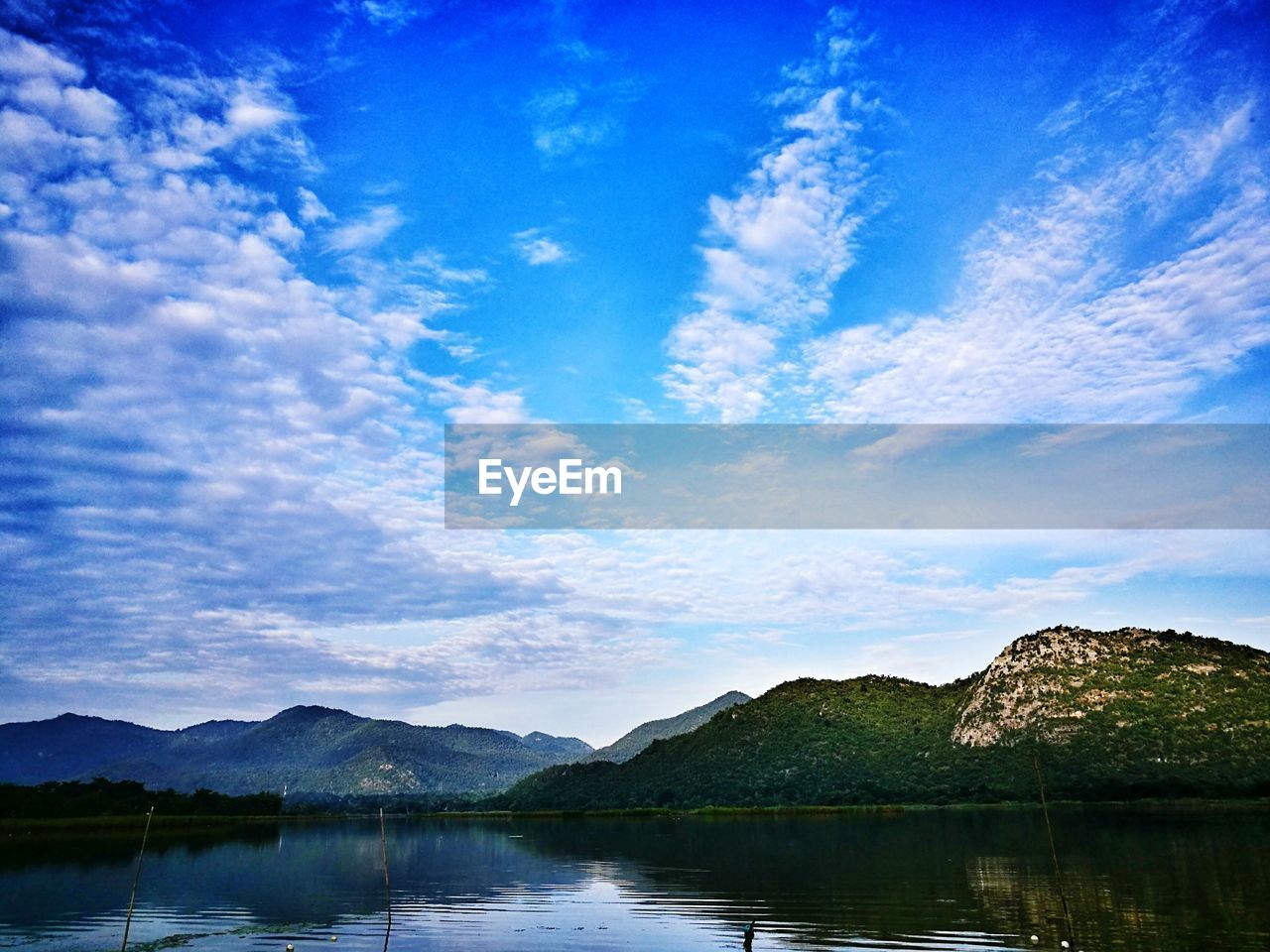 Scenic view of lake against blue sky