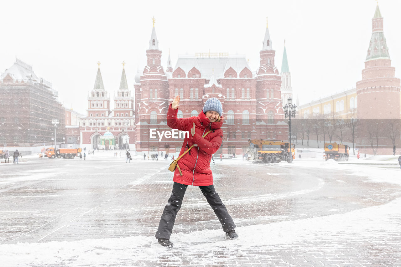 FULL LENGTH OF WOMAN STANDING IN SNOW