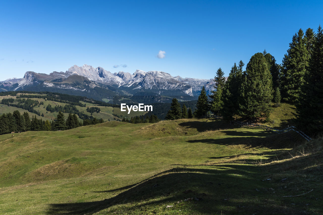 Scenic view of mountains against clear blue sky