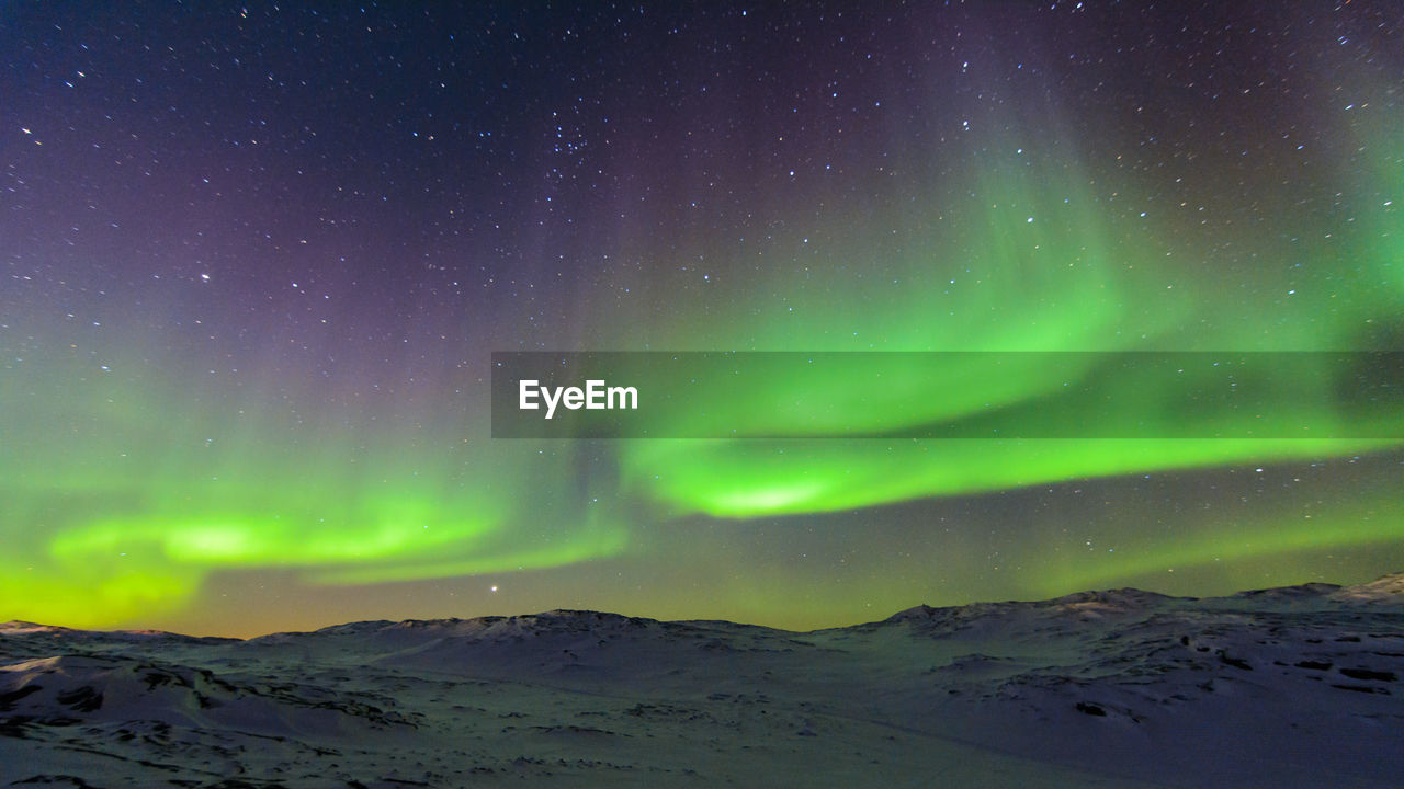 Scenic view of landscape against sky at night