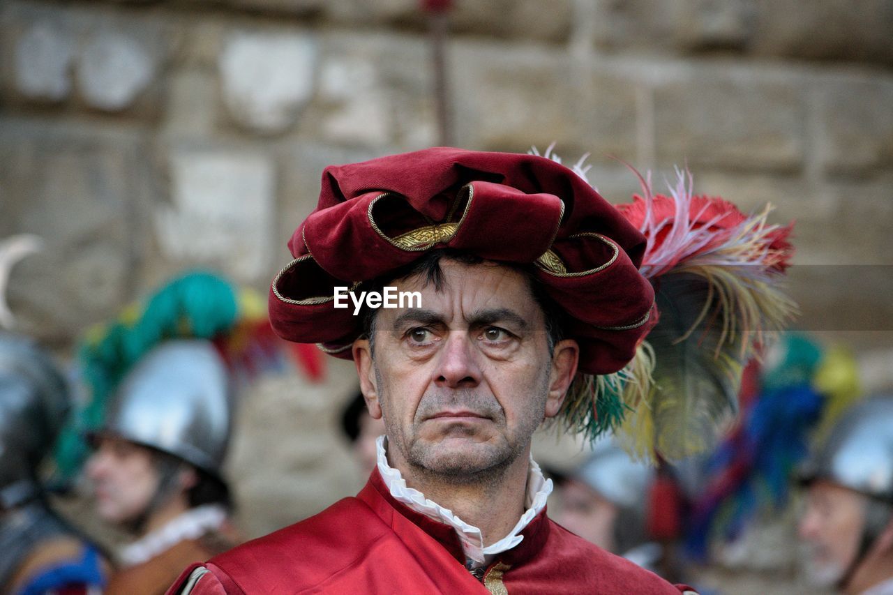 CLOSE-UP OF MID ADULT MAN IN RED ROSE