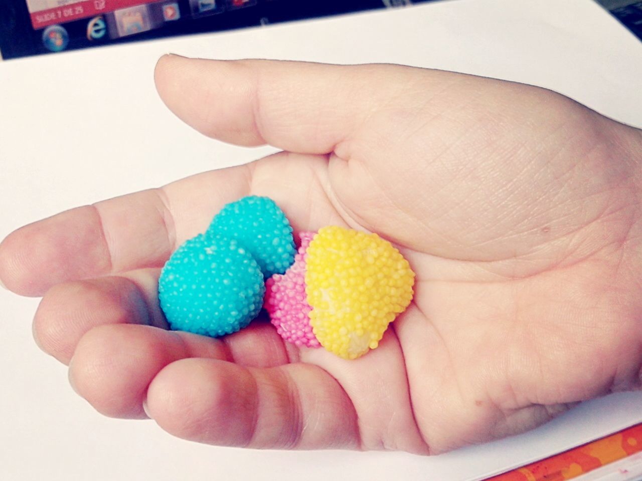 Cropped hand holding colorful candies