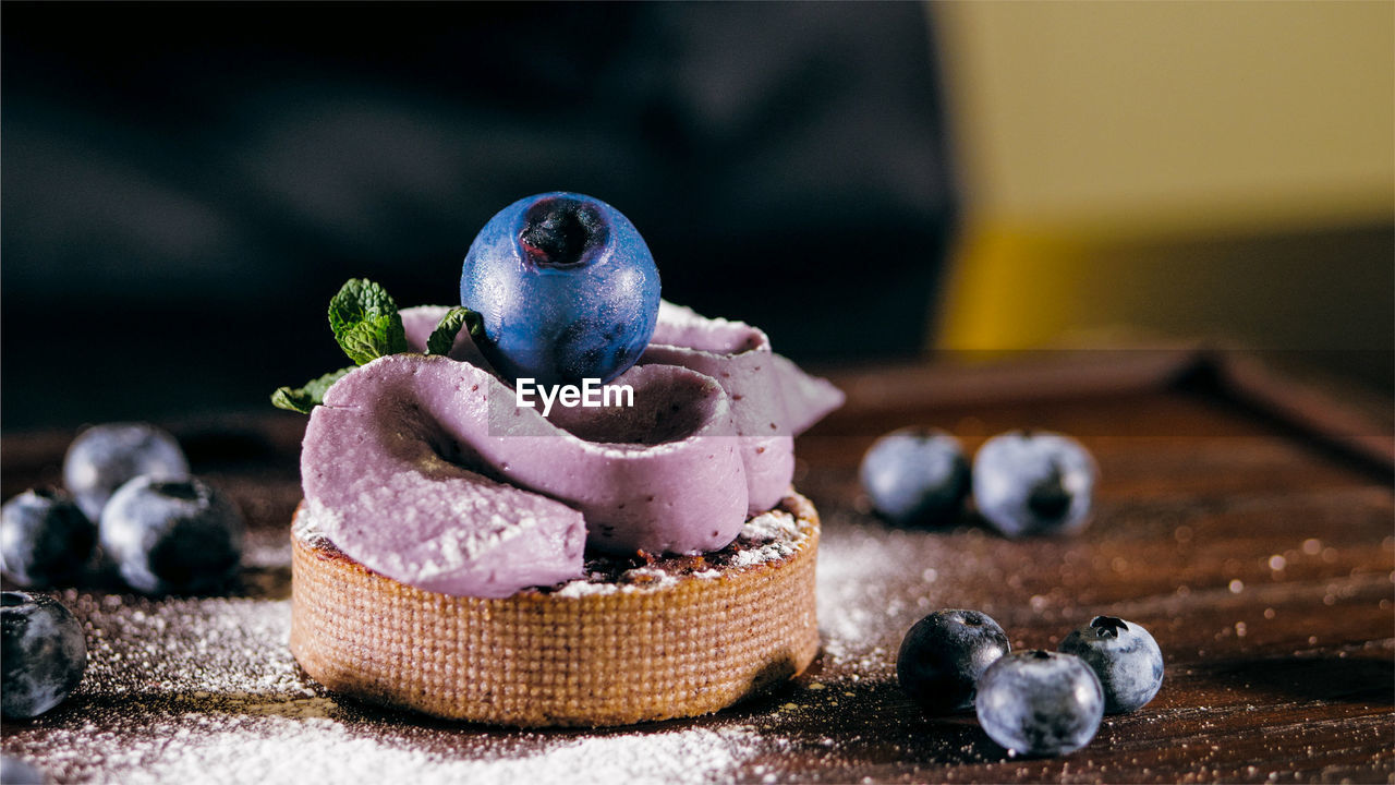 CLOSE-UP OF FRUITS IN PLATE ON TABLE