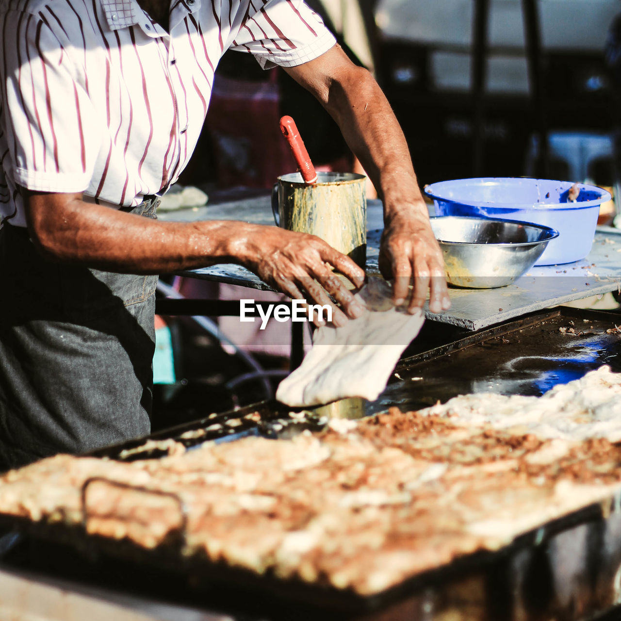 Midsection of man preparing food