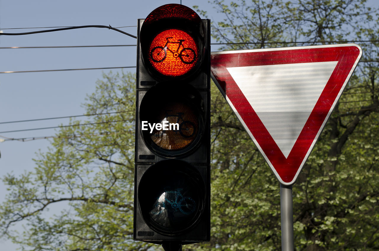 Low angle view of road signal in city