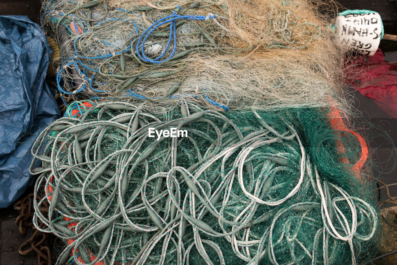 CLOSE-UP HIGH ANGLE VIEW OF FISHING NET AND CABLES