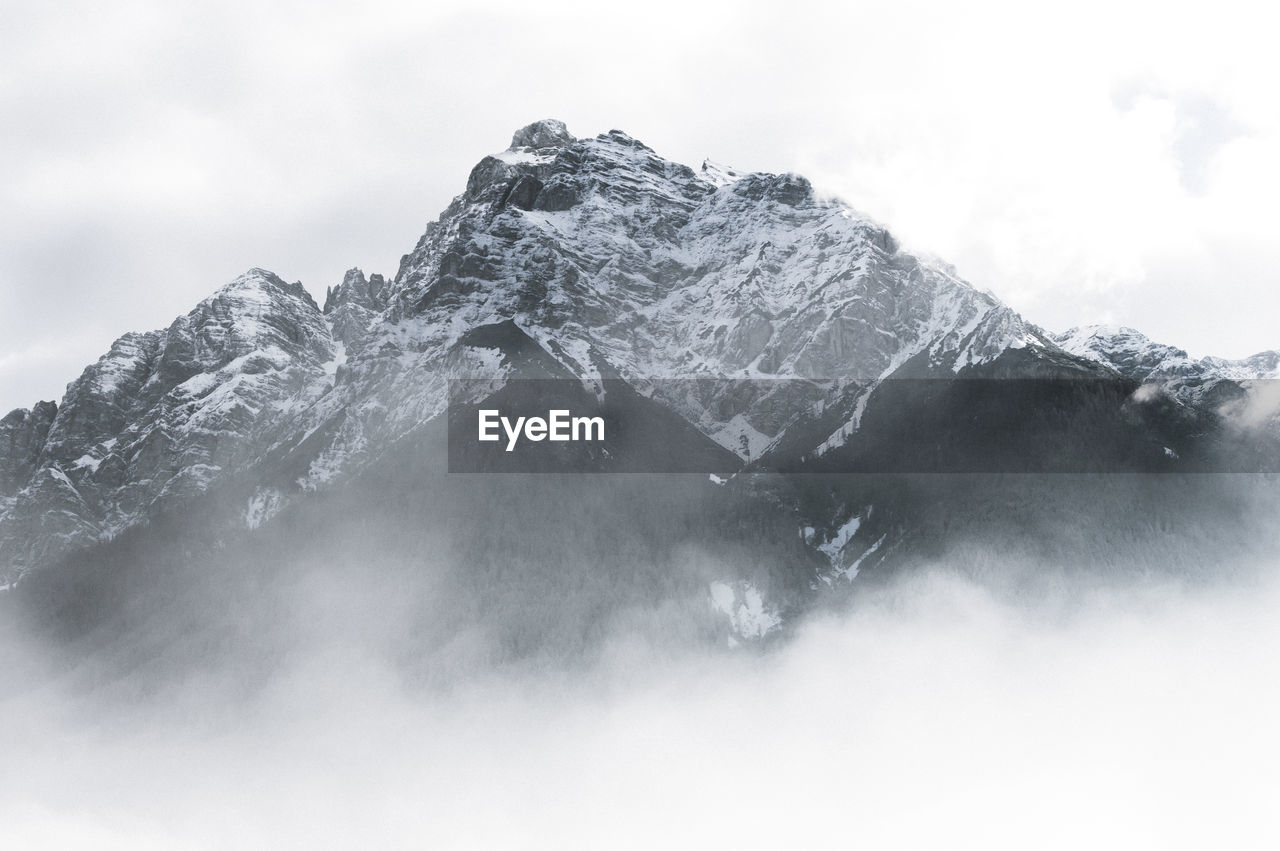 Low angle view of snowcapped mountain against sky