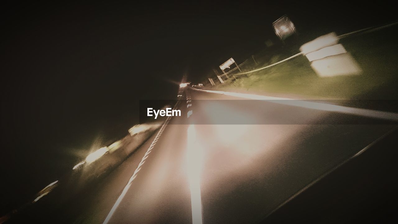 ROAD PASSING THROUGH ILLUMINATED TUNNEL
