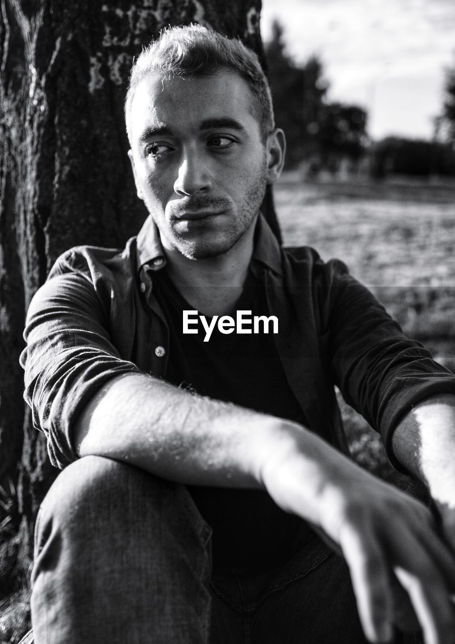 Portrait of young man sitting outdoors