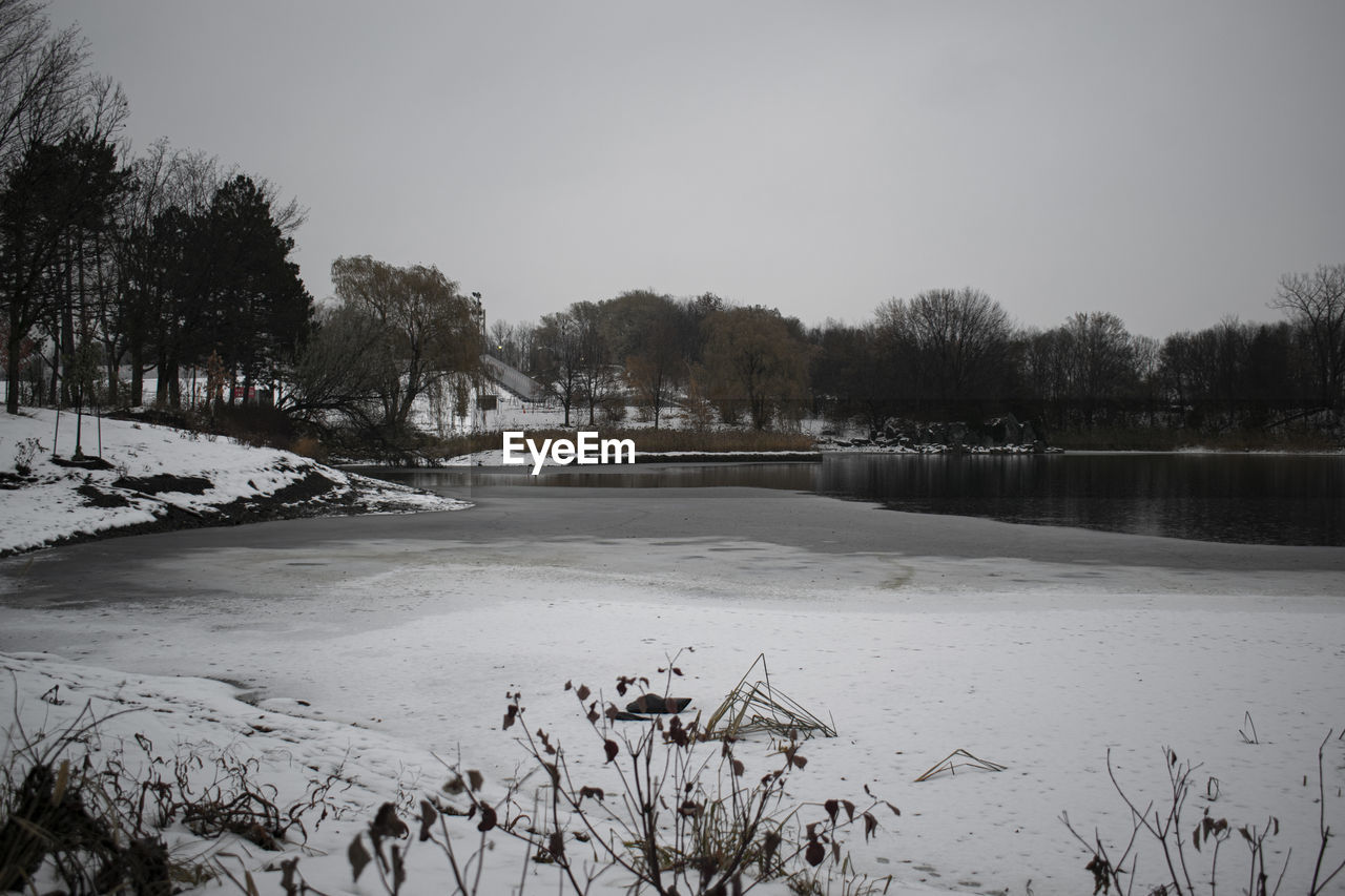 Scenic view of frozen lake against sky during winter