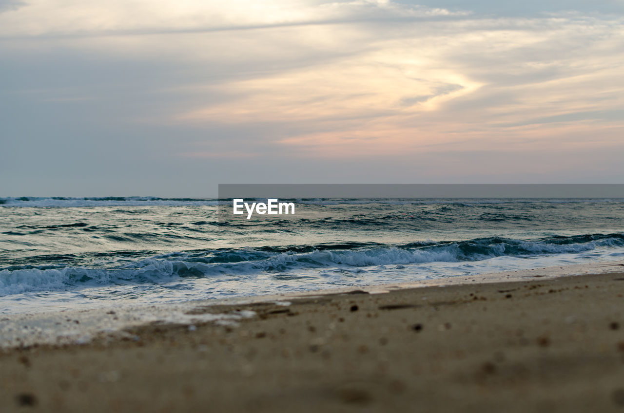 Scenic view of beach against sky during sunset