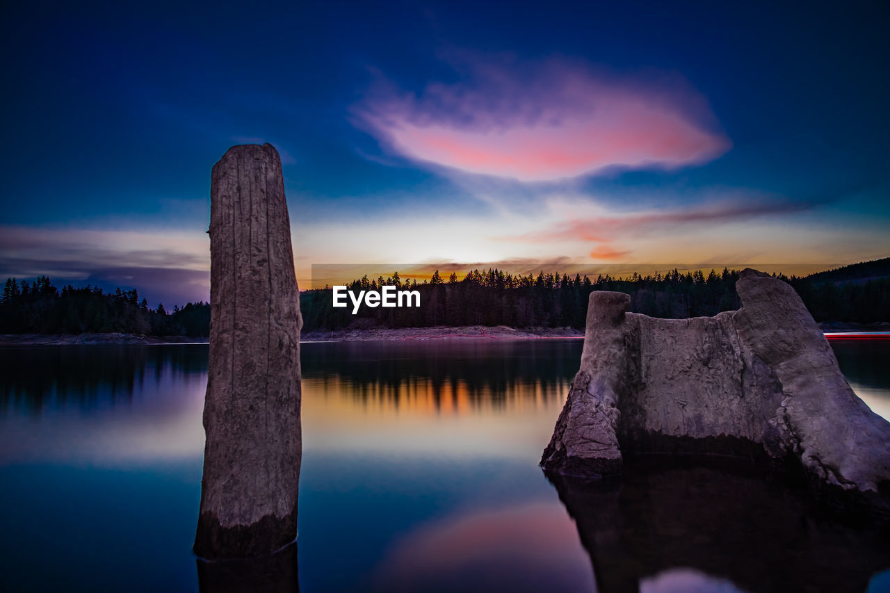 Scenic view of lake against sky at sunset