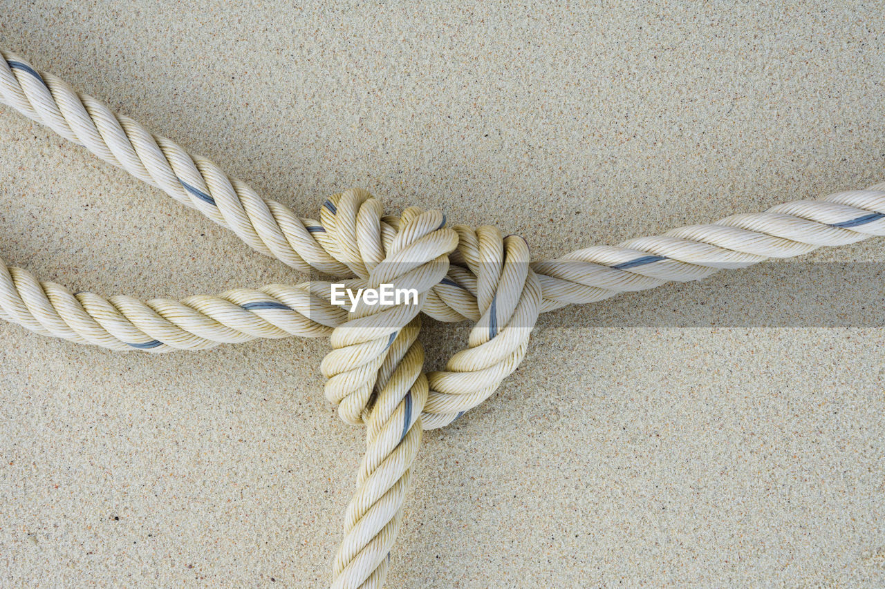 Close-up of tied rope against wall