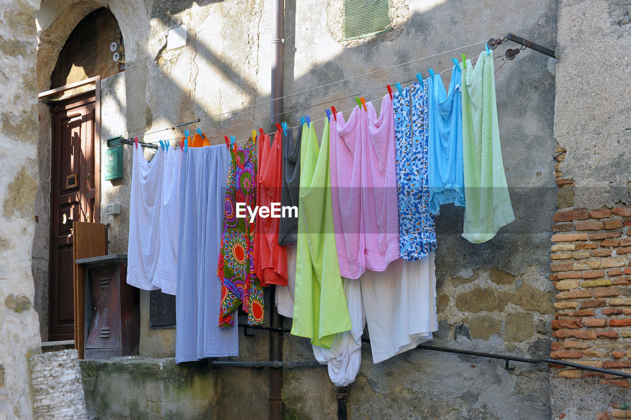 LOW ANGLE VIEW OF CLOTHES DRYING ON WALL