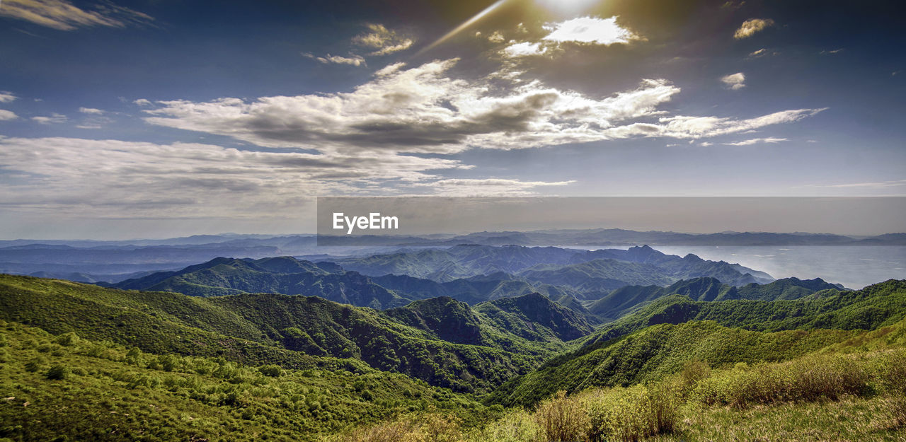 Looking down at the beautiful green mountains in the distance from a high place