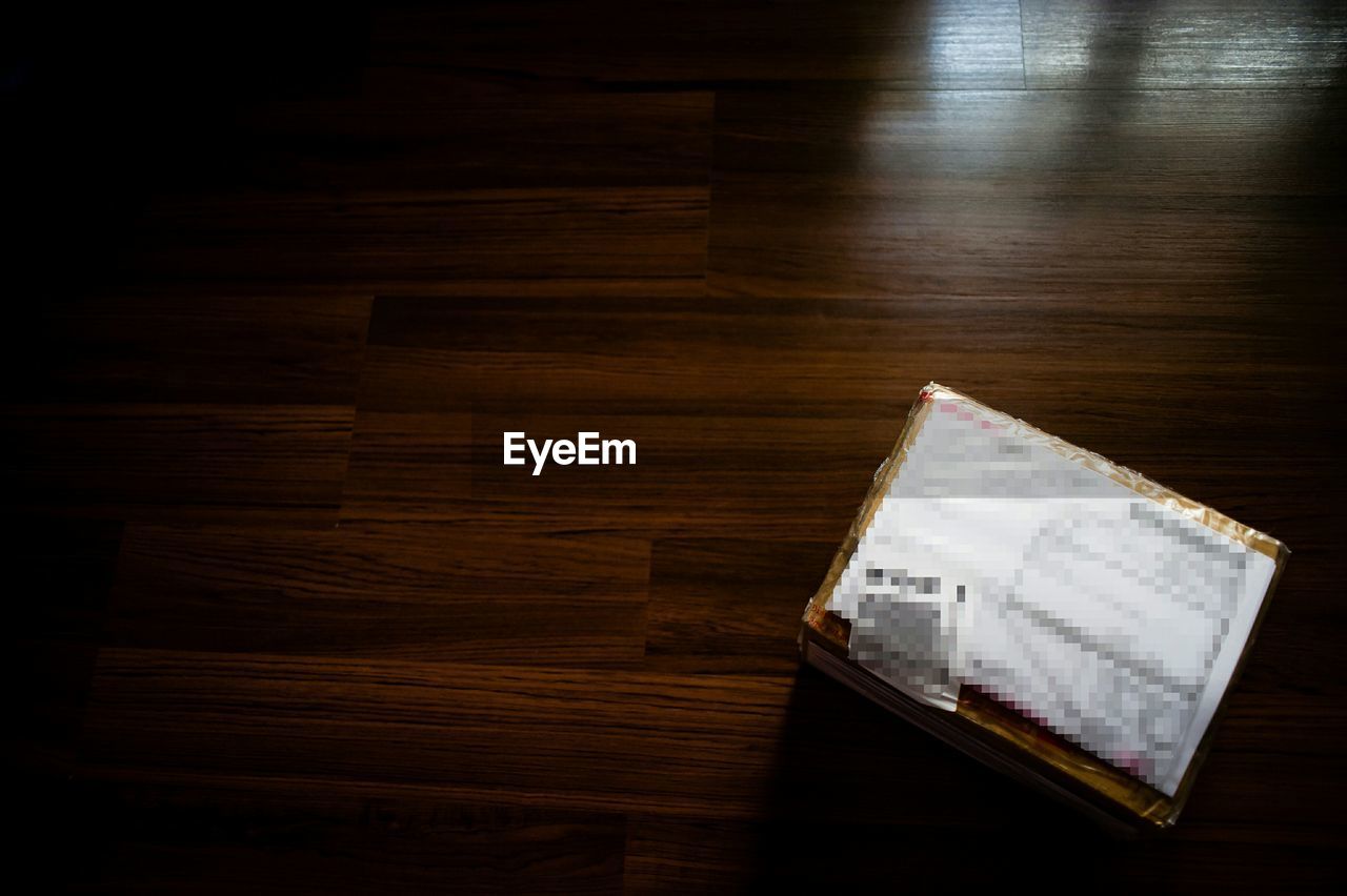 CLOSE-UP OF OPEN BOOK ON TABLE