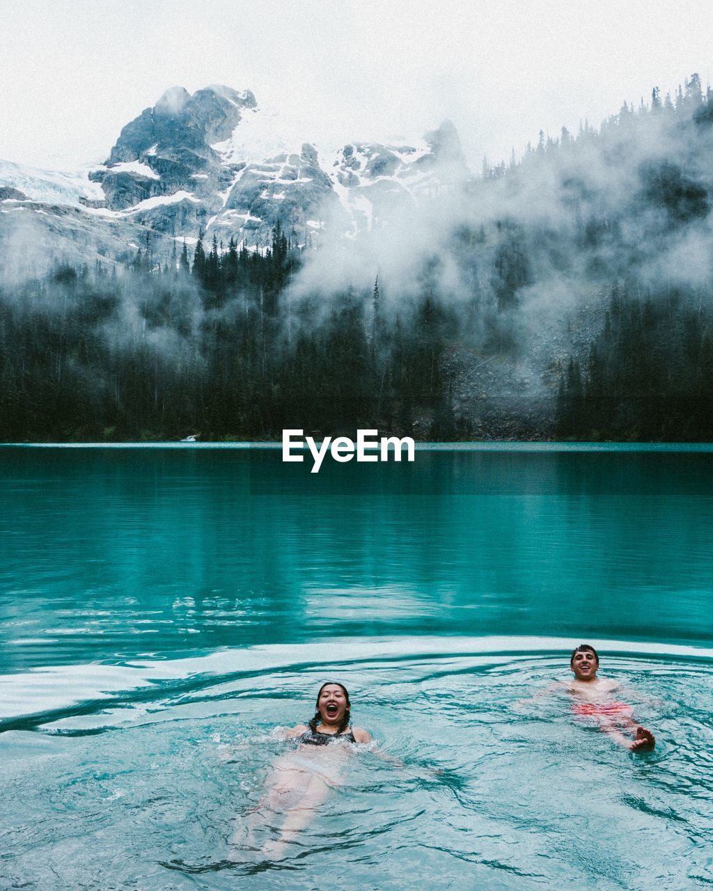 Couple swimming in water