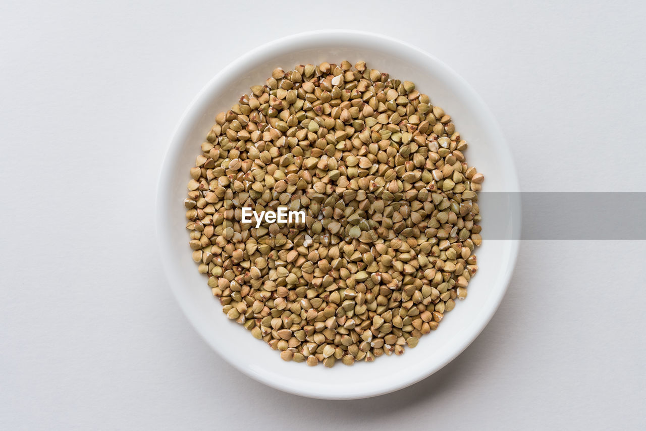 high angle view of seeds in bowl on white background