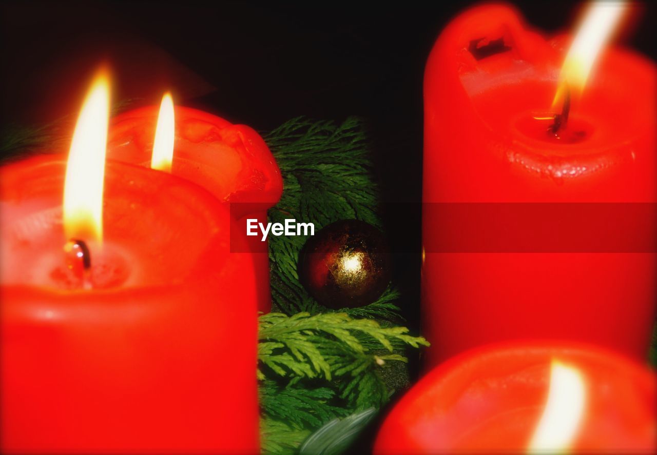 High angle view of illuminated red candles with christmas decoration