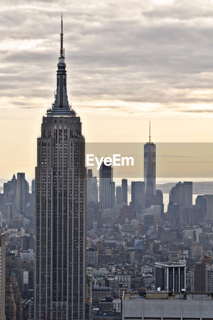 View of cityscape against cloudy sky