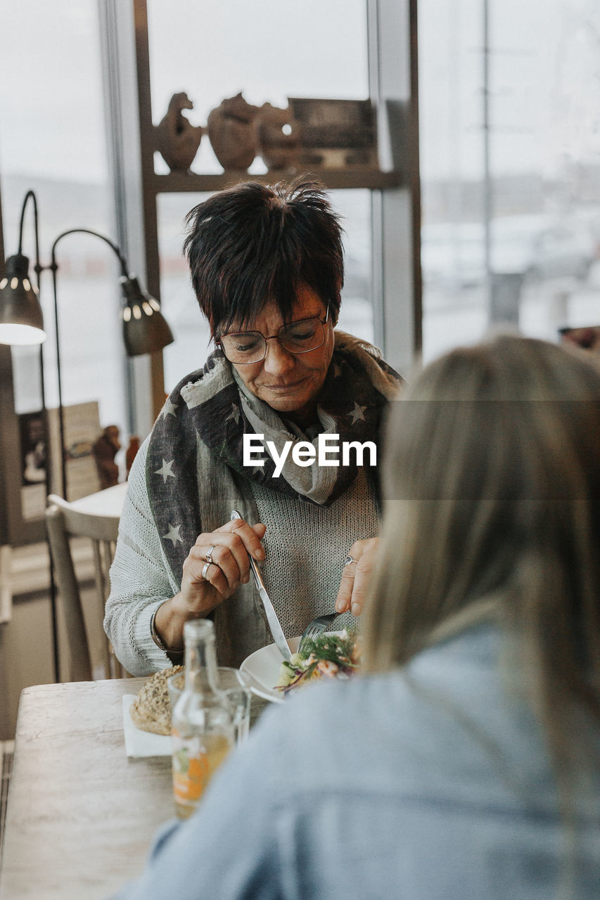 Woman having meal in cafe