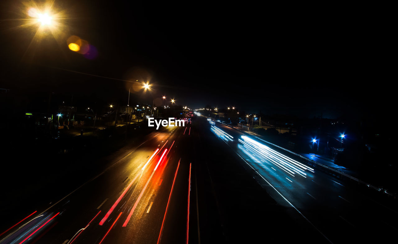 Light trails on road in city at night